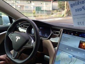 A Tesla car operating in Autopilot mode, where the car is driving itself- instead of being driven by the person inside or an unseen hacker. (Source: Marc van der Chijs.)